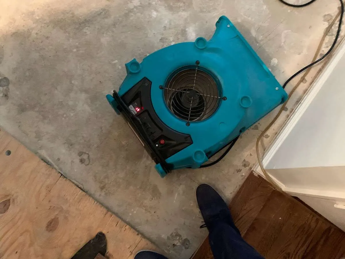 Air mover drying subfloor during Commercial Water Damage Restoration in Altus